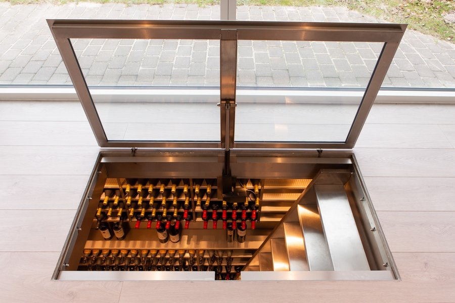 Electric wine cellar rising from the floor in a modern interior
