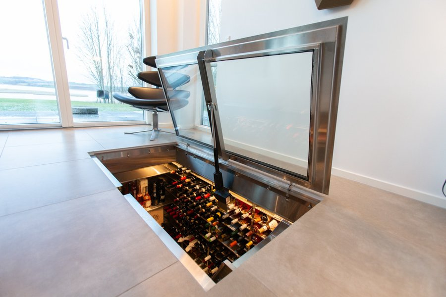 Motorized wine cellar hatch with elegant design integrated into the floor