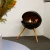 Free-standing circular bioethanol fireplace with three legs of oak wood