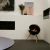 Free-standing circular bioethanol fireplace with three legs of oak wood