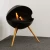 Free-standing circular bioethanol fireplace with three legs of oak wood