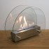 Circular tabletop fireplace wit glass panels on the sides